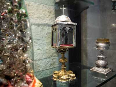 La scorgiamo all�interno di un reliquiario a forma di tabernacolo, con base e sostegno in ottone, mentre la cupoletta e la croce sono in argento